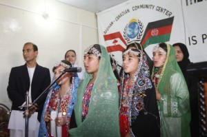 Young girls singing at the Women's Day Celebration