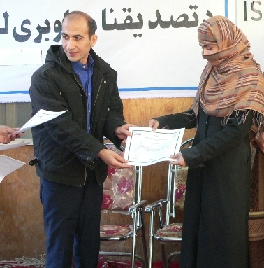 Ehsan, the Director of the Afghan Canadian Community Center, proudly issues graduation certificates to his students Ehsan, the Director of the Afghan Canadian Community Center, proudly issues graduation certificates to his students