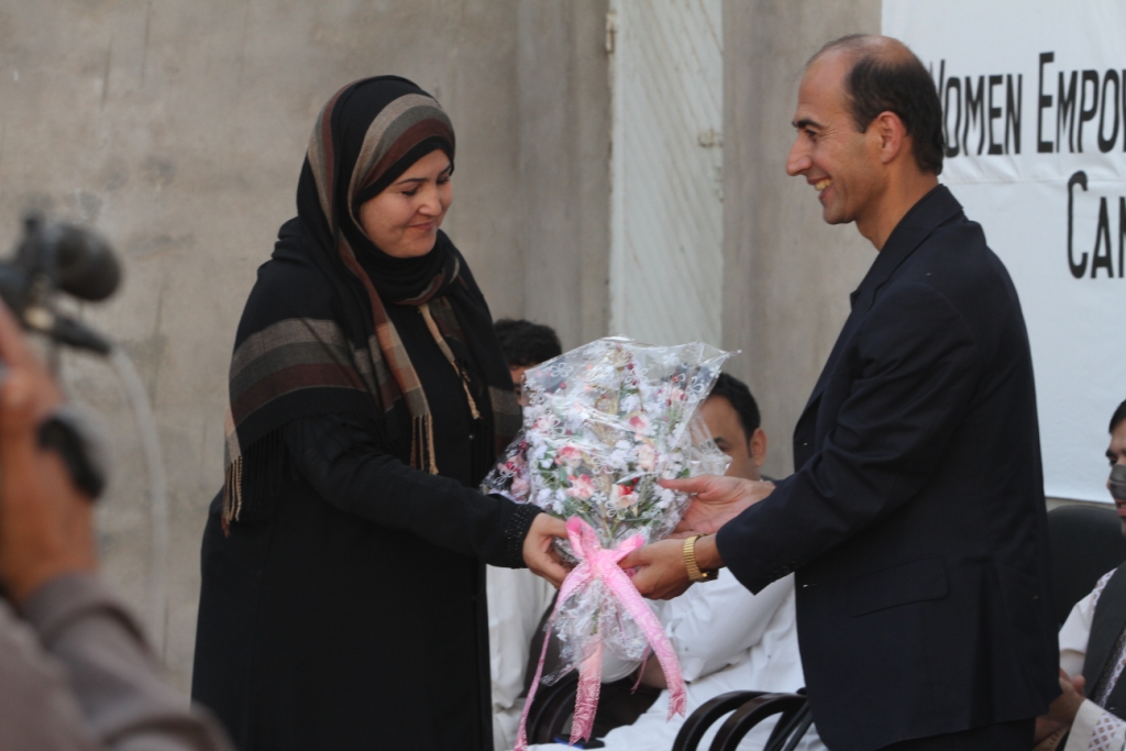 Senator Rona Tarin Receiving a Gift of Flowers From Ehsan