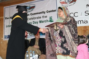 One of the graduates receives her diploma from Dr. Rangina Wisa, wife of the governor of Kandahar